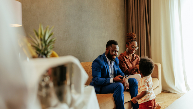 person and person on couch with child on floor