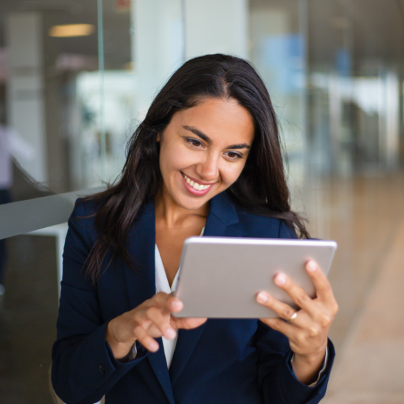 Professional female smiling and looking at tablet device.